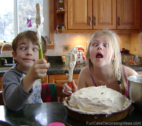 Kids having fun decorating a cake